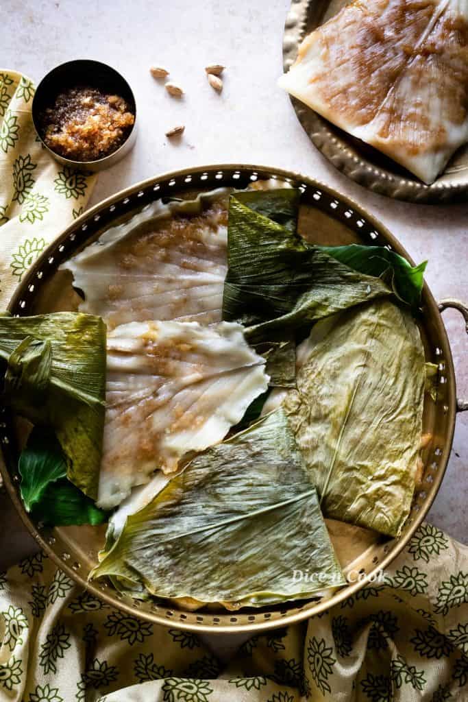 Patholi or kayi genasale are soft rice dumplings steamed in turmeric leaves. Dairy free and glutenfree coastal Karnataka recipe.  These are healthy oil-free, nut free, refined sugar dumplings #glutenfree #vegan #dumplings #steamed #patholi