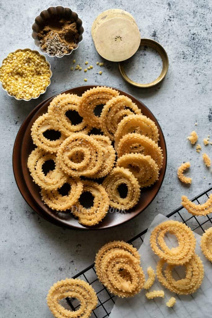 Moong dal chakli or hesaru bele chakli recipe with step by step photos and a quick detailed video. Moong dal chakli is deep fried South Indian snack. These are made of combination of rice flour and lentils. This is a easy and simple recipe. 